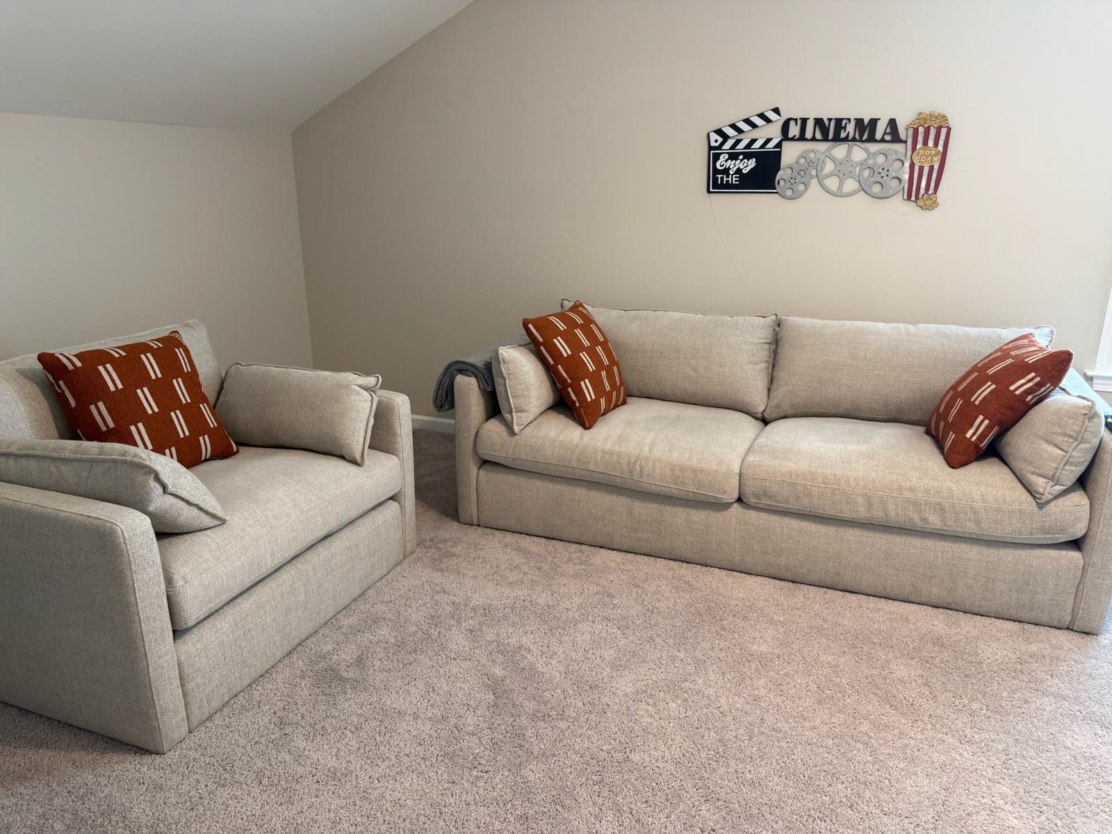 Furnished cinema room with sofa and chair